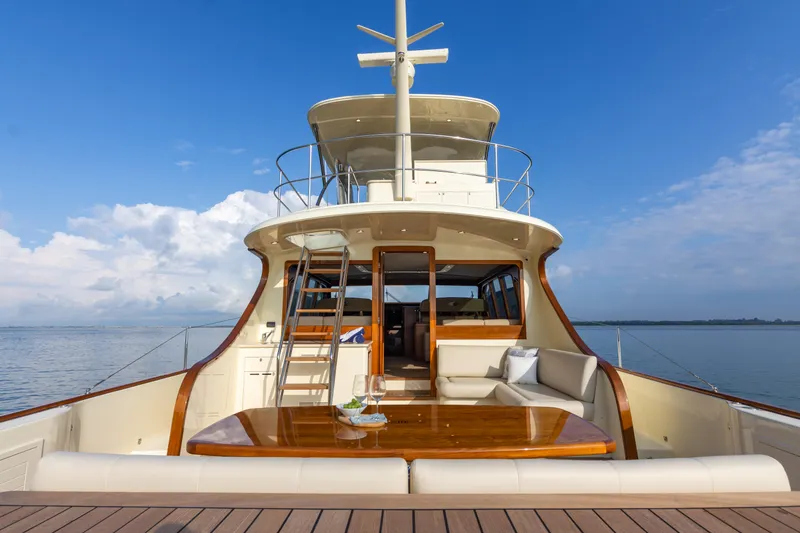 Slide: The Image of 2021 Palm Beach Motor Yachts PB65, luxurious deck view, elegant seating, ocean backdrop. - 1