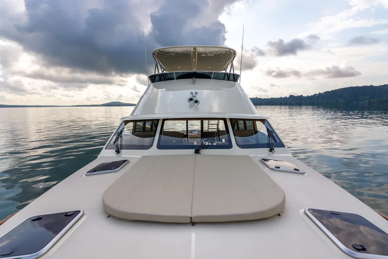 Slide: The Image of 2021 Palm Beach Motor Yachts PB65 on calm water under cloudy sky. - 11