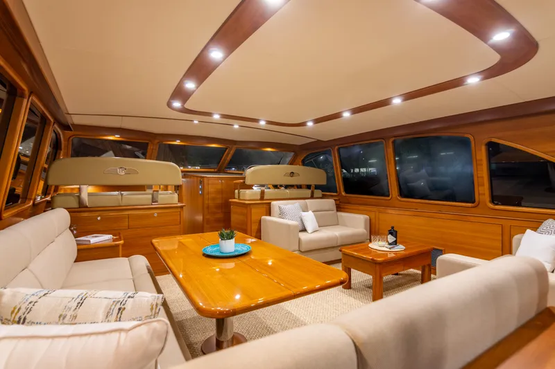 Slide: The Image of Luxurious interior of 2021 Palm Beach Motor Yachts PB65 with elegant wood finishes and plush seating. - 2