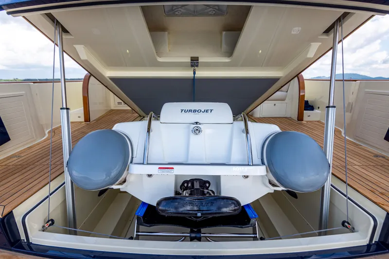 Slide: The Image of 2021 Palm Beach Motor Yachts PB65 with Turbojet tender in storage compartment. - 9