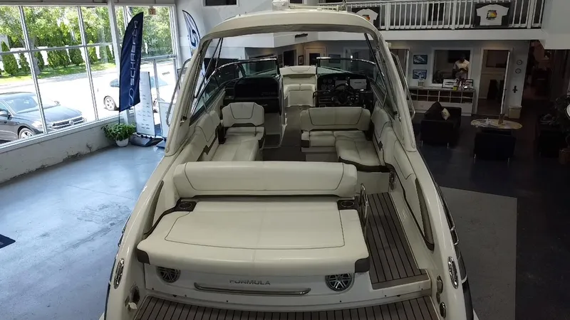 Slide: The Image of 2018 Formula 290 Bowrider boat displayed indoors, showcasing sleek design and modern features. - 12