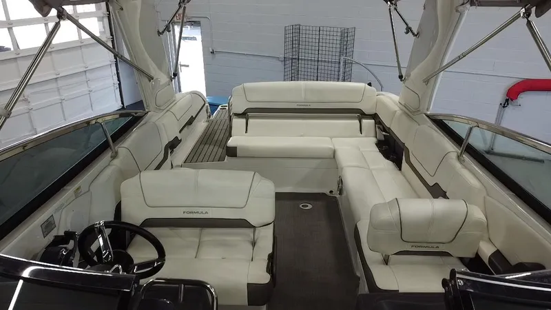 Slide: The Image of 2018 Formula 290 Bowrider interior with luxurious white seating and modern dashboard. - 14