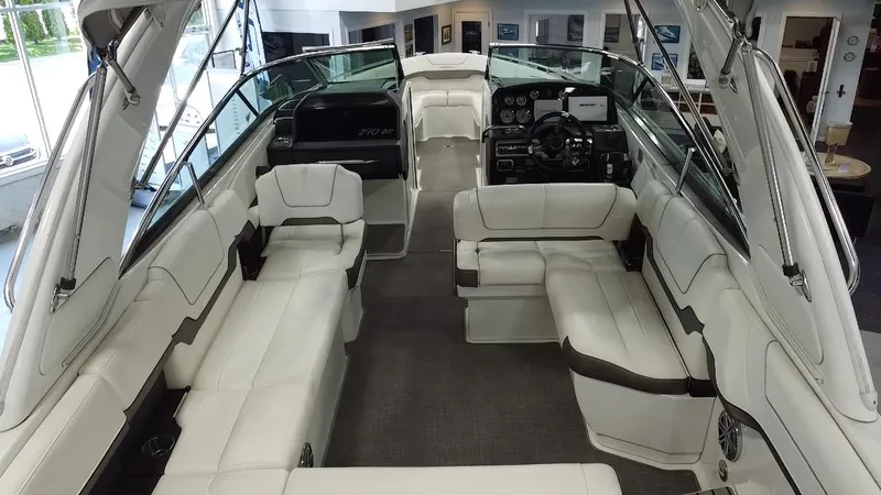 Slide: The Image of 2018 Formula 290 Bowrider with spacious seating and sleek design in a marina setting. - 15