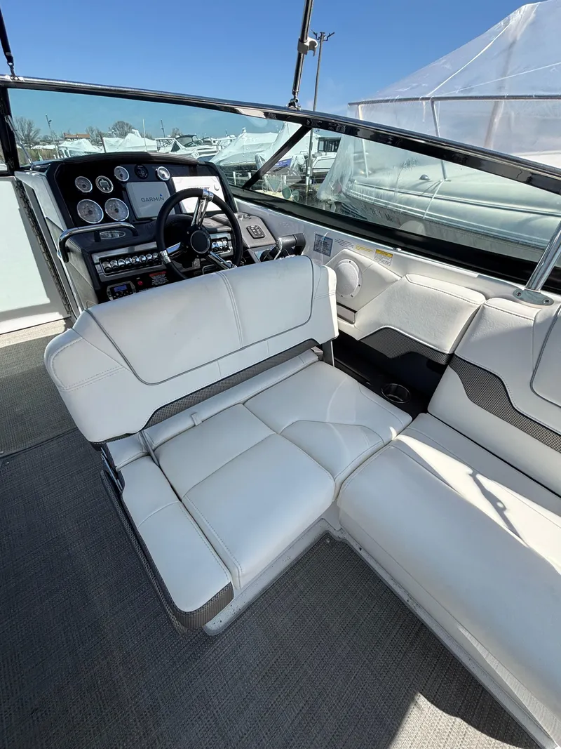 Slide: The Image of 2018 Formula 290 Bowrider interior with white seating and modern dashboard. - 18