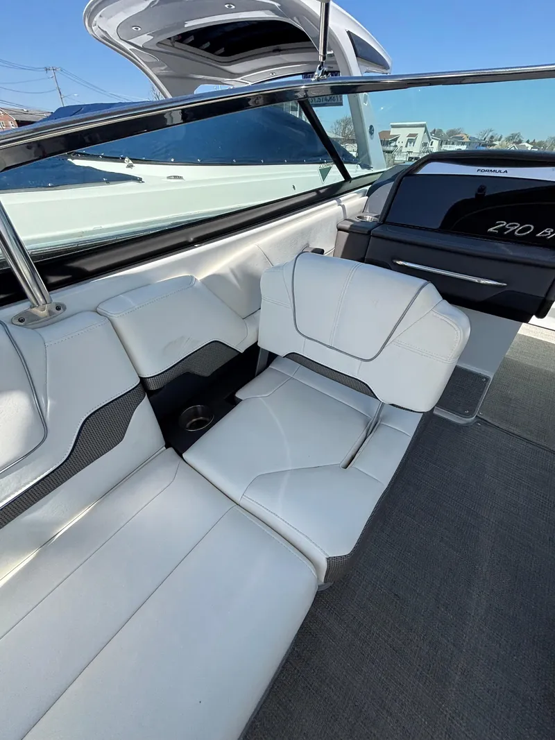 Slide: The Image of 2018 Formula 290 Bowrider interior with white seating and sleek design. - 19