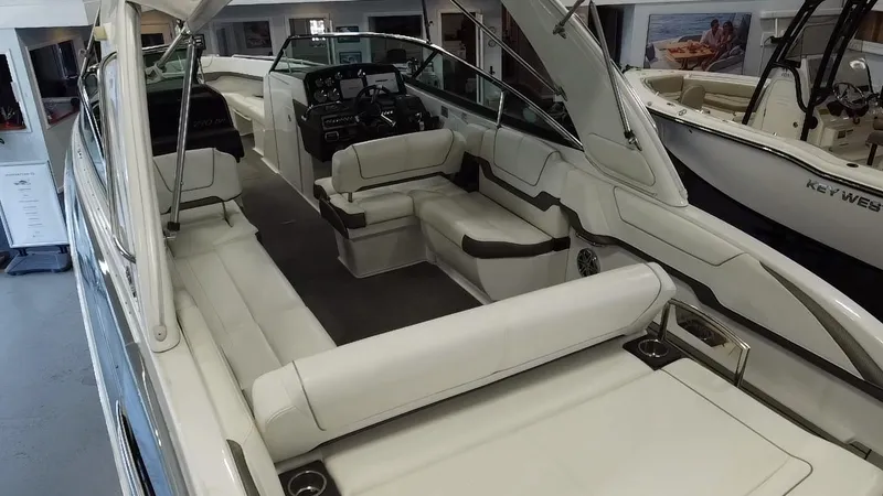 Slide: The Image of 2018 Formula 290 Bowrider boat displayed indoors, showcasing spacious deck and seating. - 22
