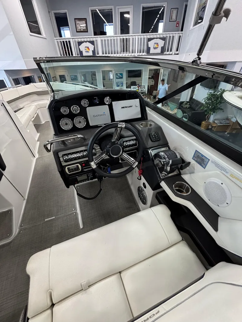 Slide: The Image of 2018 Formula 290 Bowrider dashboard with navigation and control panels, docked at marina. - 24