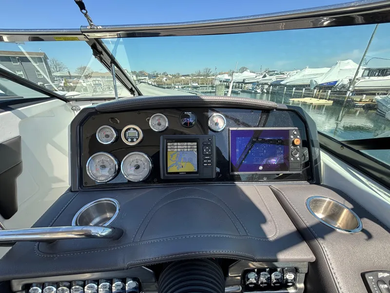 Slide: The Image of 2018 Formula 290 Bowrider interior with white seating and modern design in showroom. - 25