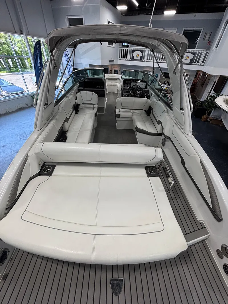 Slide: The Image of 2018 Formula 290 Bowrider interior, showcasing helm and seating in a showroom setting. - 26