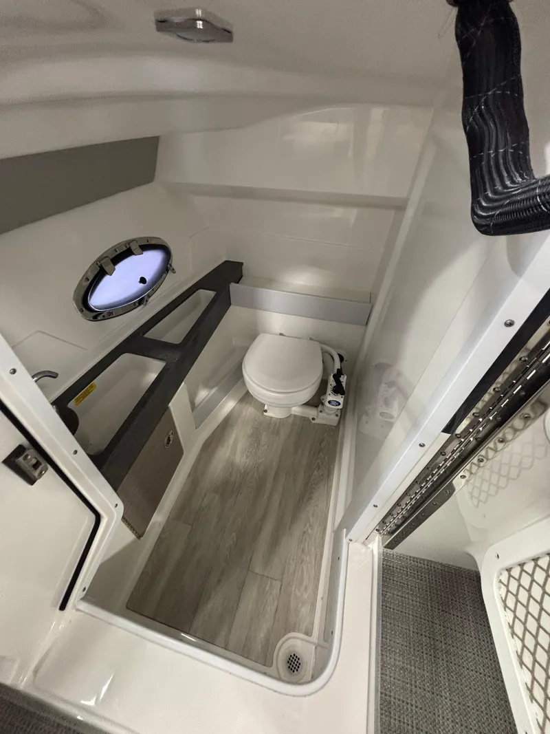 Slide: The Image of 2018 Formula 290 Bowrider interior with spacious white seating in showroom. - 30
