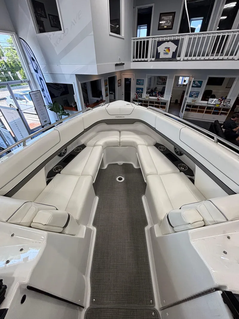 Slide: The Image of 2018 Formula 290 Bowrider interior with white leather seating in showroom. - 31