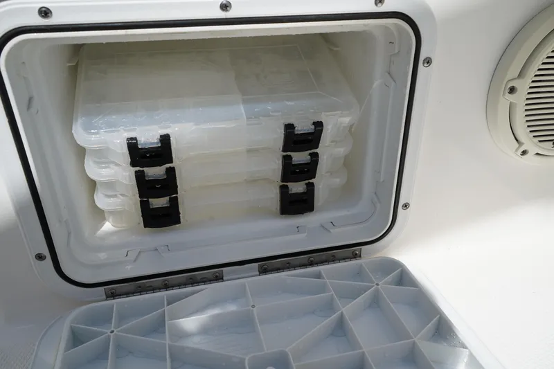 Slide: The Image of Storage compartment with tackle boxes on a 2021 Edgewater 188CC boat. - 12