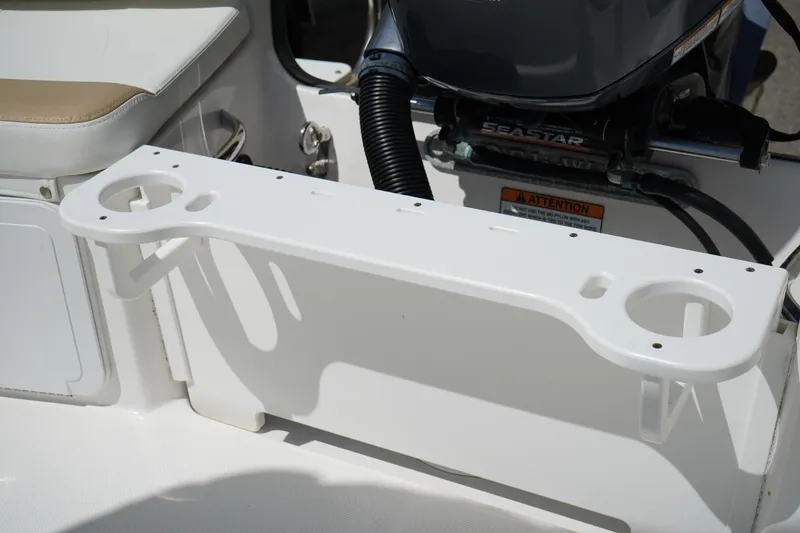 Slide: The Image of 2021 Edgewater 188CC boat interior with cup holders and seating area. - 13
