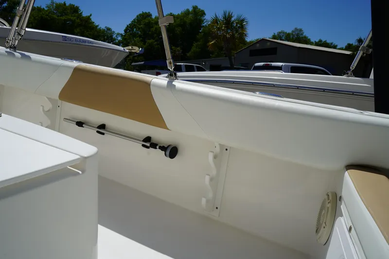 Slide: The Image of 2021 Edgewater 188CC boat interior with rod holders and seating under clear blue sky. - 14