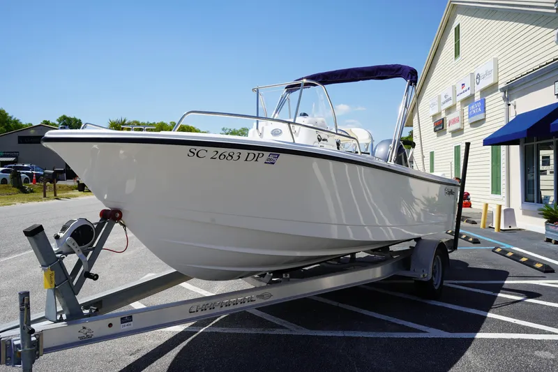 Slide: The Image of 2021 Edgewater 188CC boat on trailer, parked outside a building on a sunny day. - 3