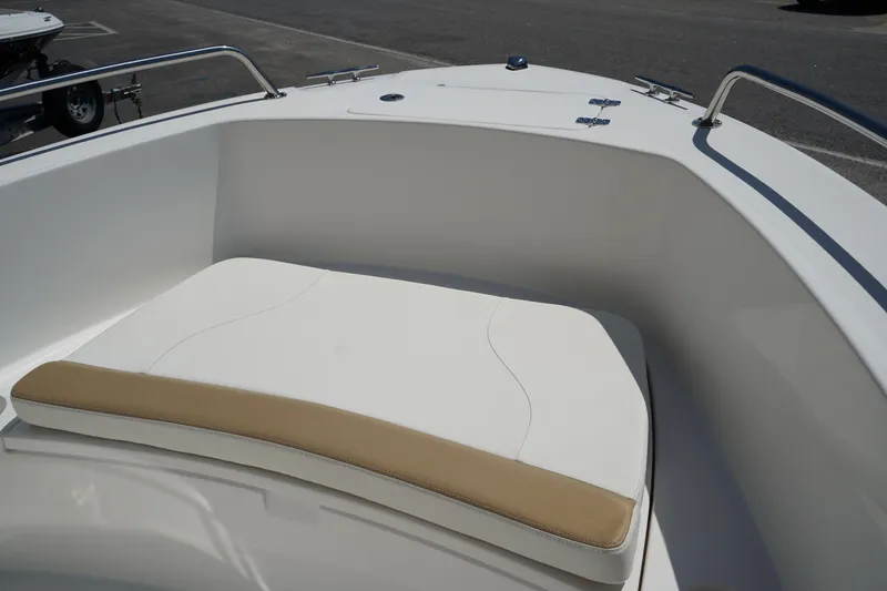 Slide: The Image of 2021 Edgewater 188CC boat bow with cushioned seating, featuring sleek white design and stainless steel rails. - 35