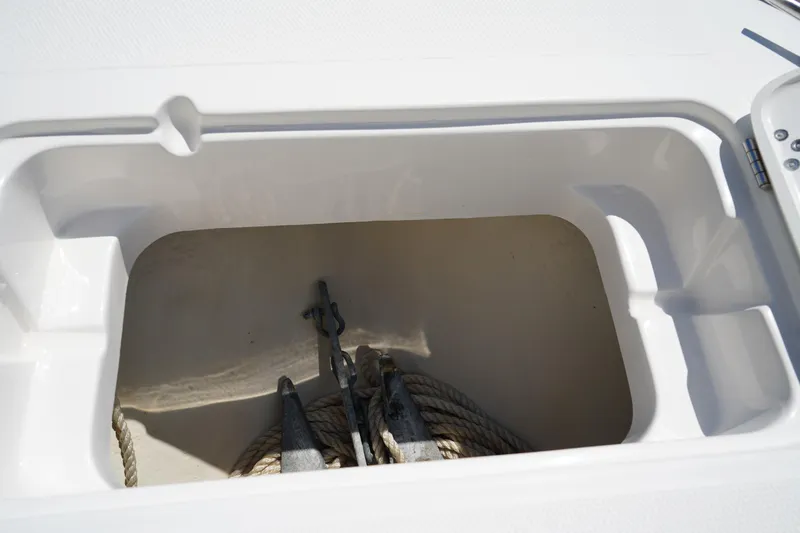 Slide: The Image of Anchor storage compartment on a 2021 Edgewater 188CC boat, featuring ropes and anchor. - 37
