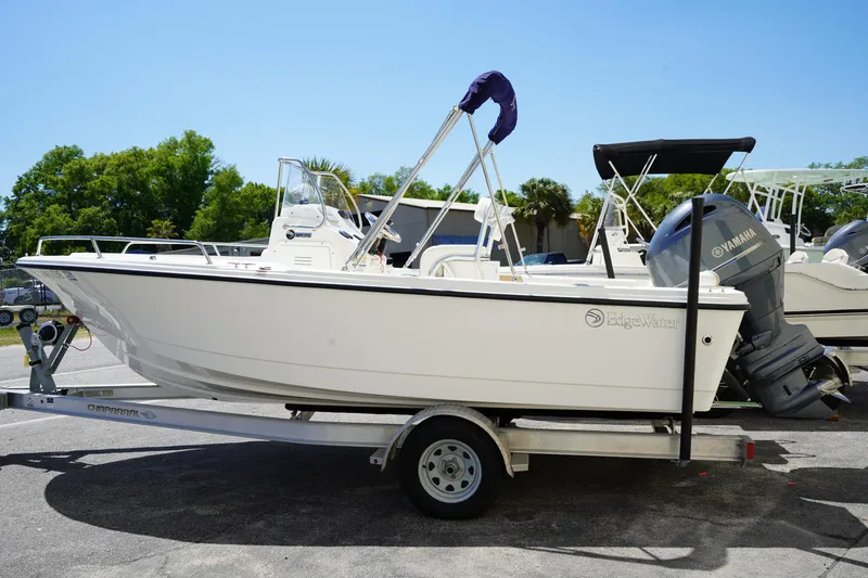 Slide: The Image of 2021 Edgewater 188CC boat on trailer with Yamaha outboard motor, parked outdoors. - 4
