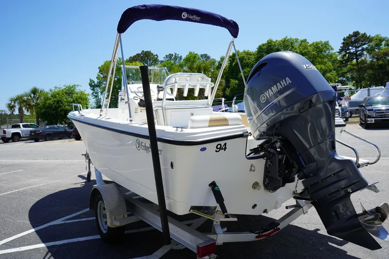 Slide: The Image of 2021 Edgewater 188CC boat on trailer with Yamaha outboard motor in parking lot. - 6