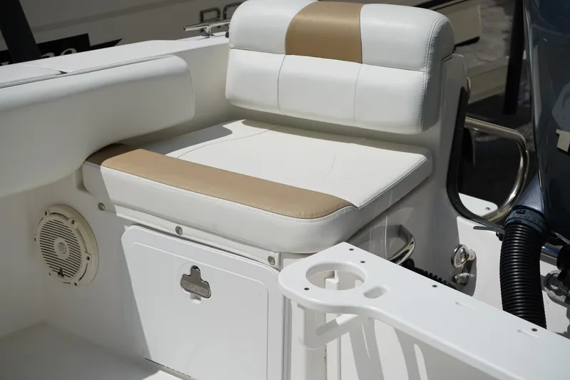 Slide: The Image of 2021 Edgewater 188CC boat seat with white and tan upholstery, featuring a built-in speaker. - 9