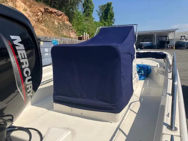 Slide: The Image of 2020 Boston Whaler 170 Montauk boat with Mercury engine, covered console, parked outdoors. - 4