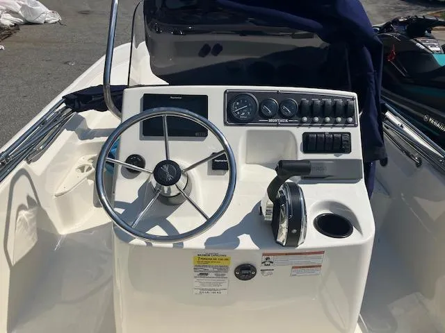 Slide: The Image of 2020 Boston Whaler 170 Montauk boat console with steering wheel and controls. - 7