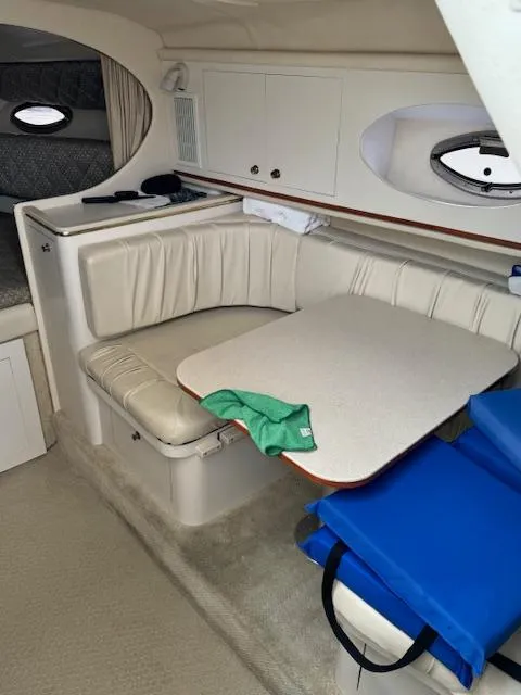 Slide: The Image of 2001 Sea Ray Amberjack cabin interior with dining area and seating. - 10