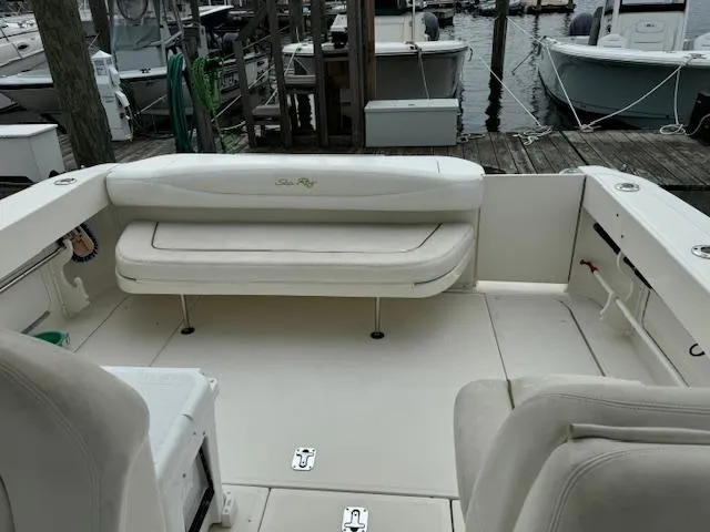 Slide: The Image of 2001 Sea Ray Amberjack boat interior with white seating at a marina dock. - 5