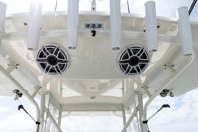 Slide: The Image of 2022 SeaVee 370z boat with speakers and rod holders on the T-top. - 13