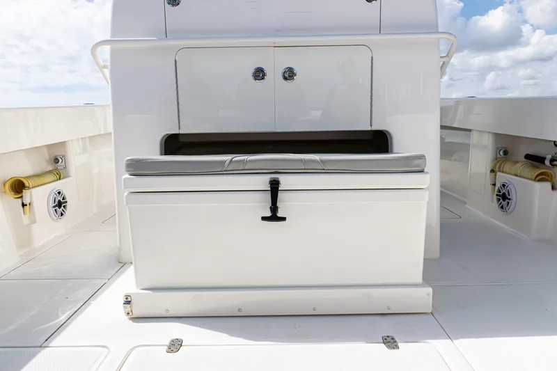 Slide: The Image of 2022 SeaVee 370z boat deck with storage compartment and cushioned seating. - 15