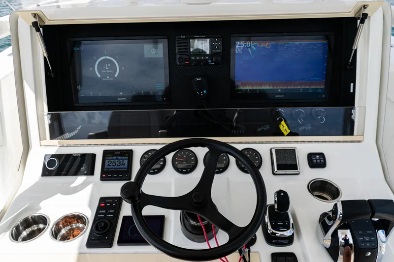 Slide: The Image of Control panel of 2022 SeaVee 370z boat with steering wheel and navigation screens. - 16