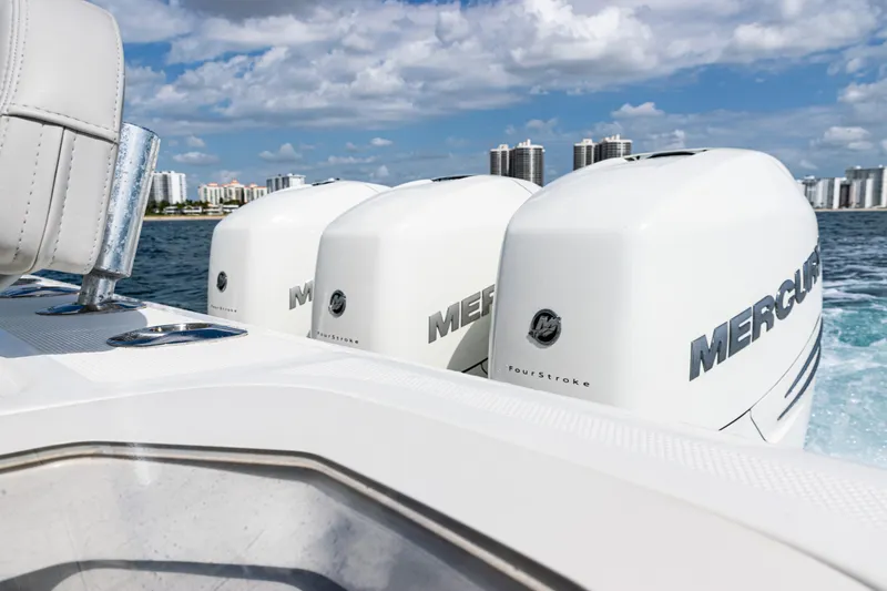Slide: The Image of 2022 SeaVee 370z boat with triple Mercury engines cruising on water. - 17