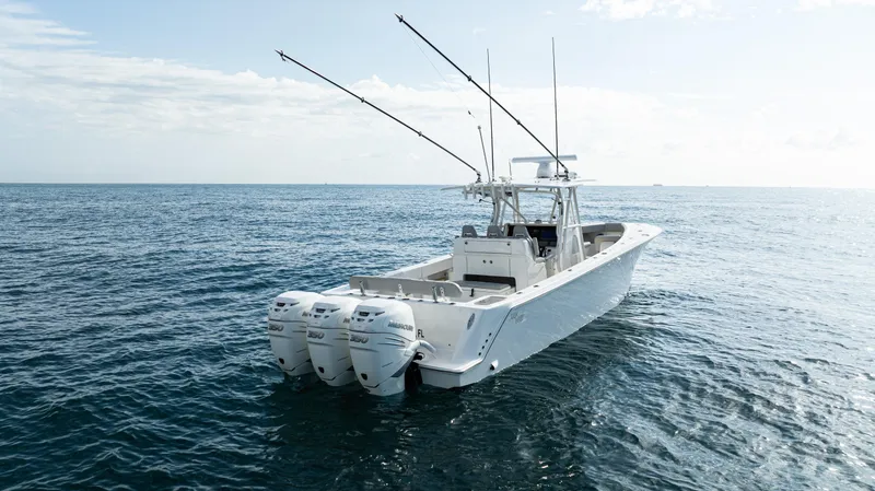 Slide: The Image of 2022 SeaVee 370z boat cruising on open water with city skyline in background. - 2