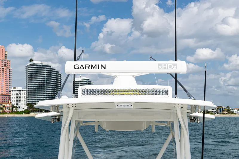 Slide: The Image of SeaVee 370z 2022 boat with Garmin radar, ocean view, and city skyline background. - 23