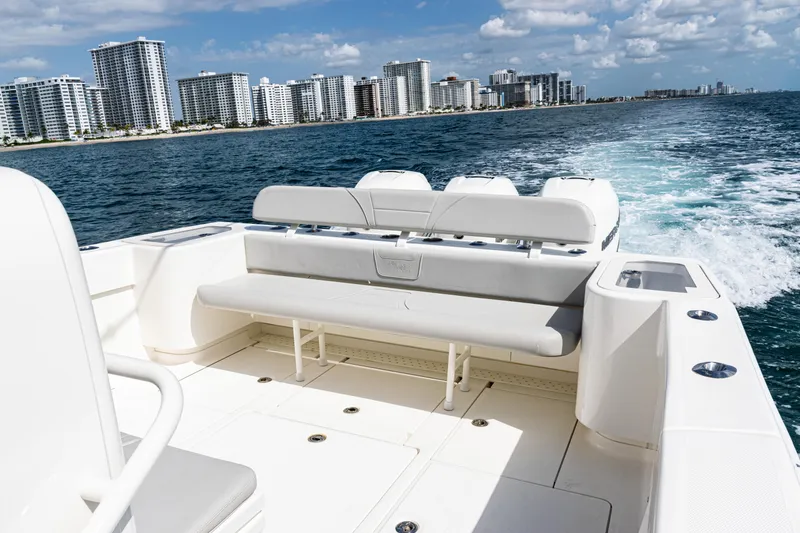 Slide: The Image of 2022 SeaVee 370z boat cruising near city skyline on a sunny day. - 24