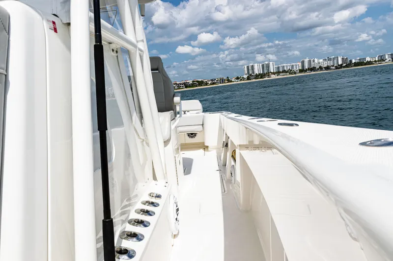 Slide: The Image of 2022 SeaVee 370z boat cruising on a sunny day with city skyline in background. - 32