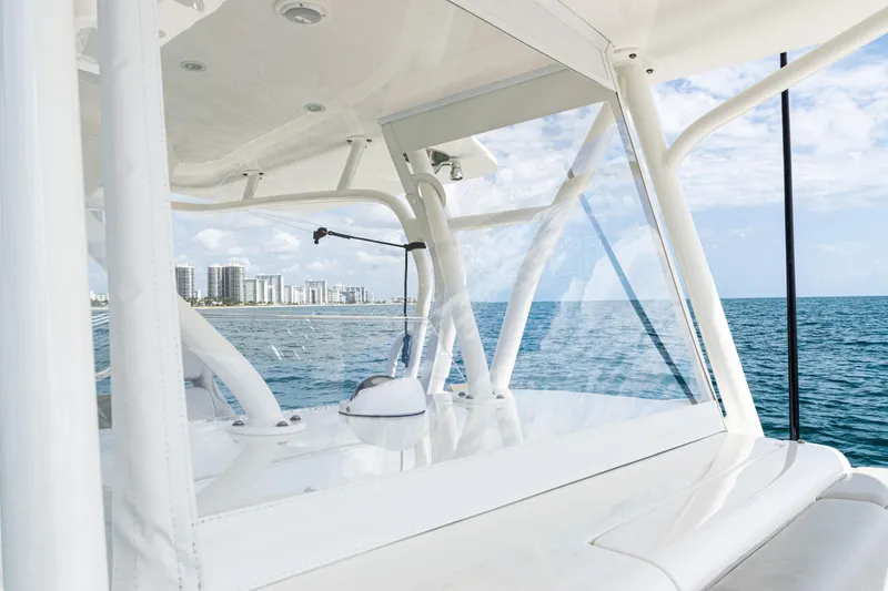 Slide: The Image of 2022 SeaVee 370z boat on ocean, city skyline in background, clear skies. - 33