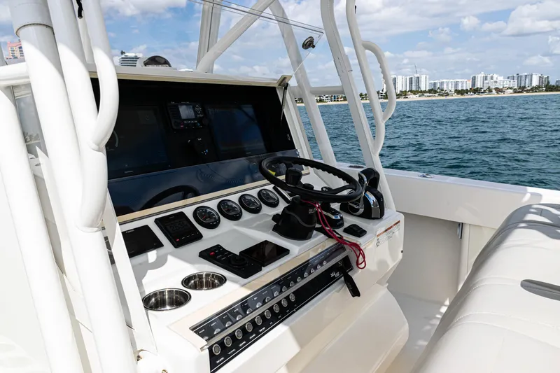 Slide: The Image of 2022 SeaVee 370z boat console with steering wheel, gauges, and ocean view. - 34