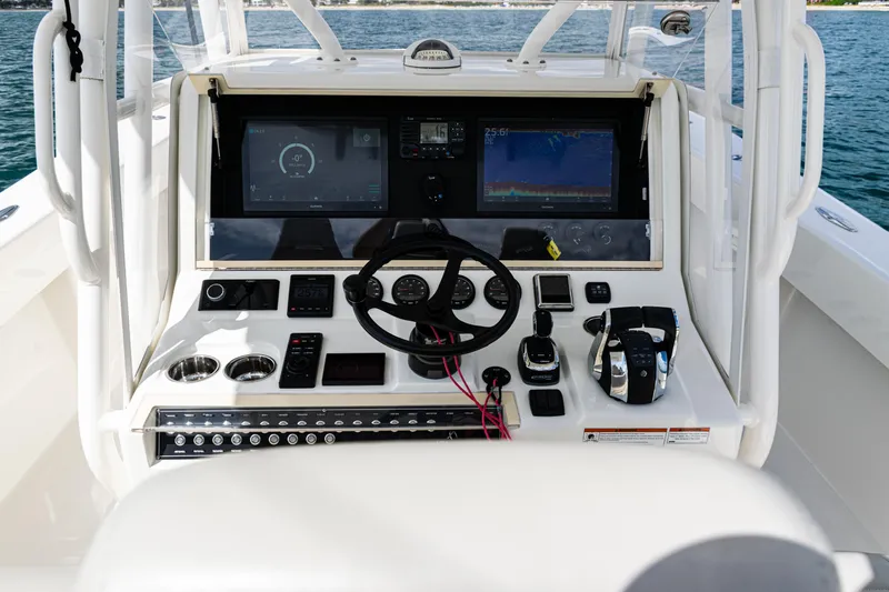Slide: The Image of 2022 SeaVee 370z boat dashboard with steering wheel and navigation screens. - 35