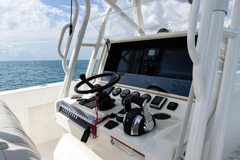 Slide: The Image of 2022 SeaVee 370z boat helm with steering wheel and controls, ocean view in background. - 37