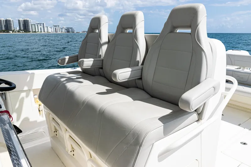 Slide: The Image of Three comfortable seats on a 2022 SeaVee 370z boat, with ocean and city skyline in background. - 40