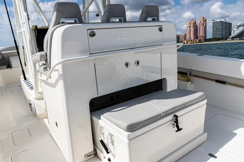 Slide: The Image of 2022 SeaVee 370z boat interior with seating and storage, ocean view in background. - 41