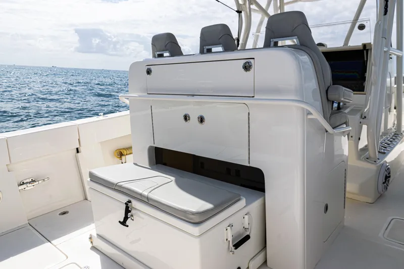 Slide: The Image of 2022 SeaVee 370z boat interior with seating and storage, ocean in background. - 42