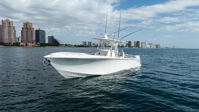 Slide: The Image of 2022 SeaVee 370z boat on ocean with city skyline in background. - 47