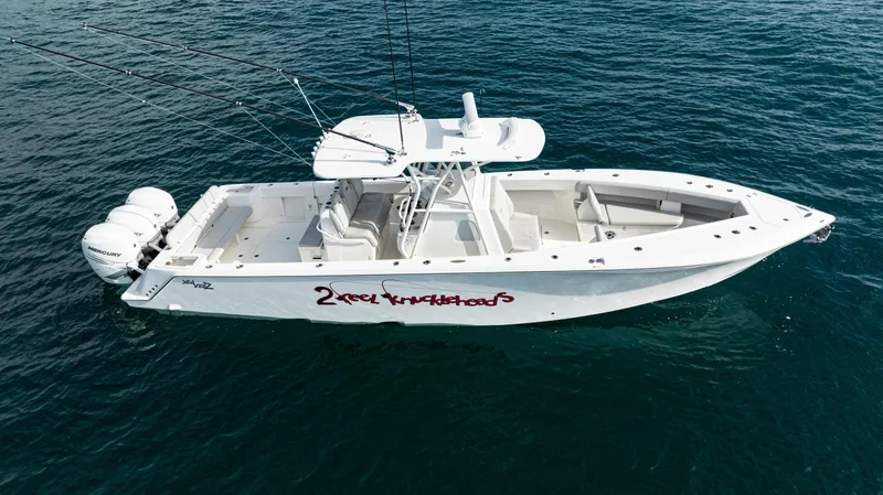 Slide: The Image of 2022 SeaVee 370z boat on open water, featuring triple outboard engines. - 49