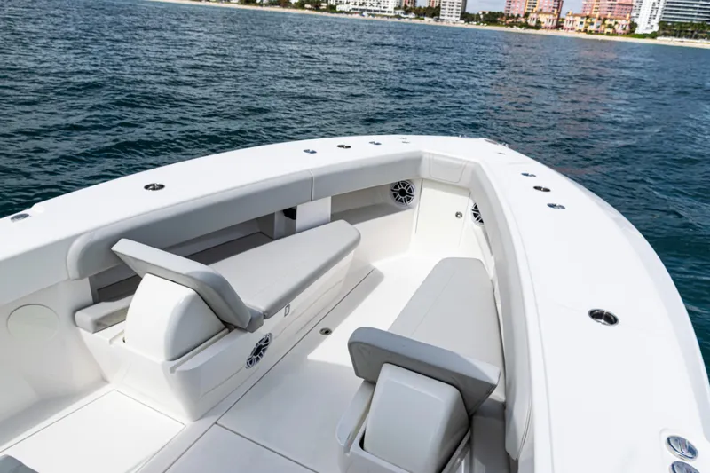Slide: The Image of 2022 SeaVee 370z boat interior with seating, on calm ocean near shoreline. - 7