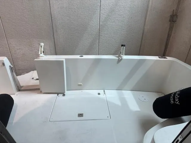 Slide: The Image of 2003 Carver 360 Sport Sedan boat interior with white seating and rod holders. - 10