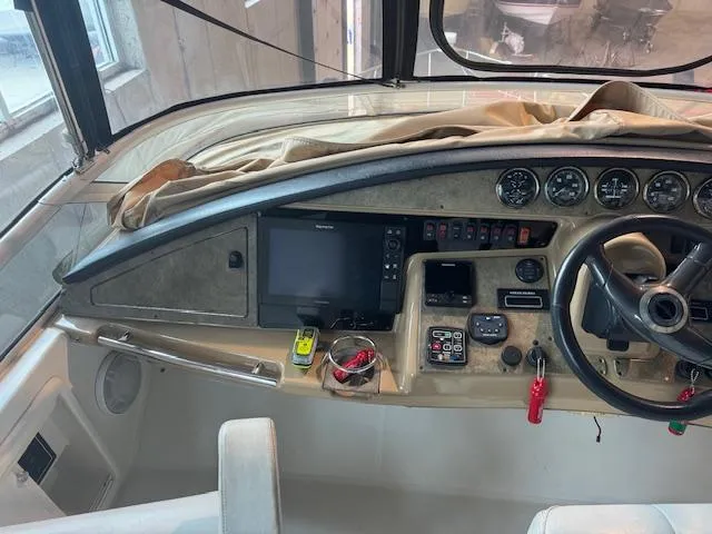 Slide: The Image of 2003 Carver 360 Sport Sedan helm with navigation instruments and steering wheel. - 13