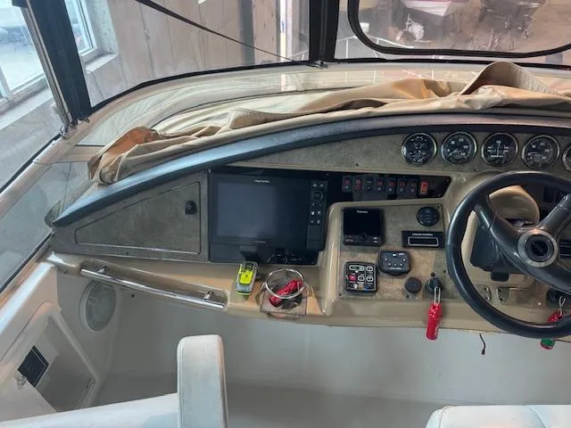 Slide: The Image of 2003 Carver 360 Sport Sedan helm with navigation instruments and steering wheel. - 14