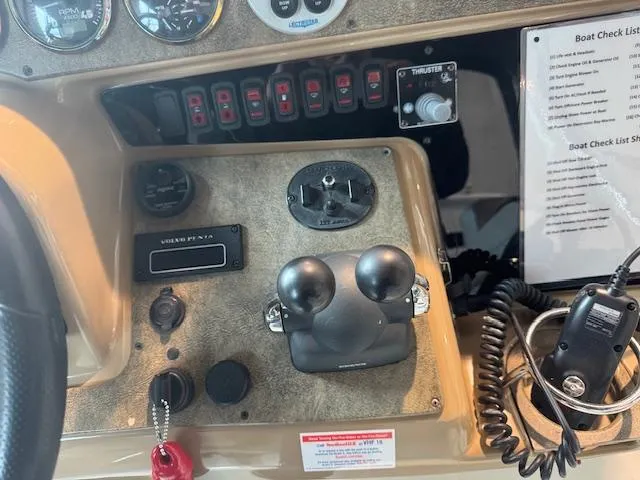 Slide: The Image of Control panel of a 2003 Carver 360 Sport Sedan boat with various switches and gauges. - 17
